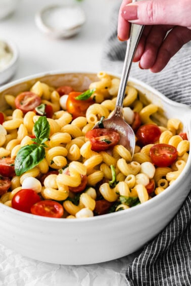 Caprese Pasta salad with dressing on top.