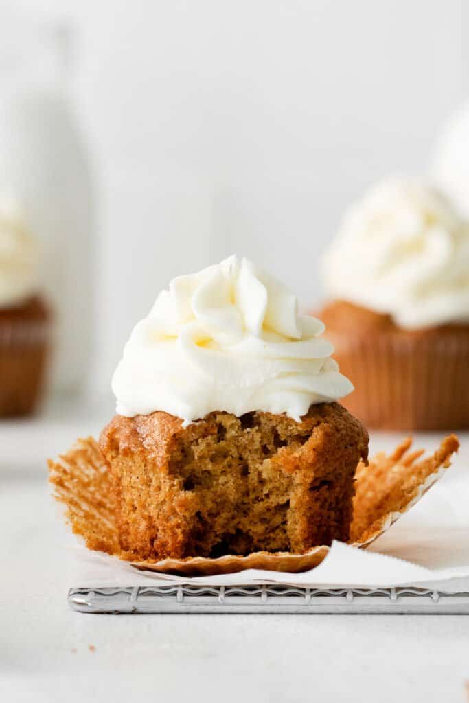 A carrot cake cupcake on parchment paper. 