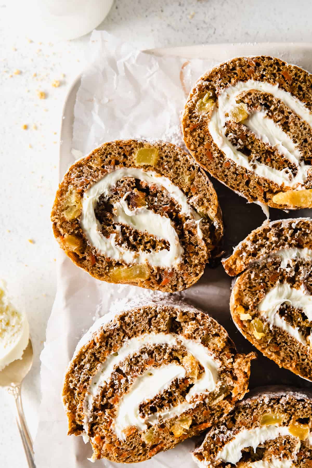 carrot cake roll sliced on a plate