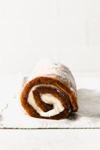 a pumpkin roll is sitting on a piece of paper.
