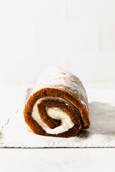 a pumpkin roll is sitting on a piece of paper.