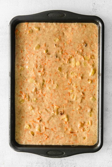 carrot cake in a baking pan on a white background.