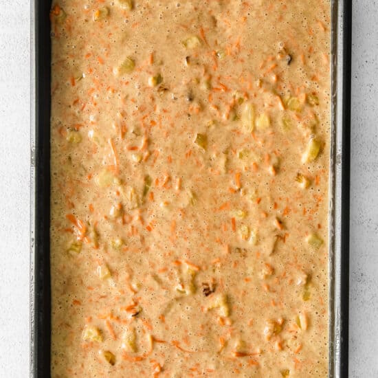 carrot cake in a baking pan on a white background.