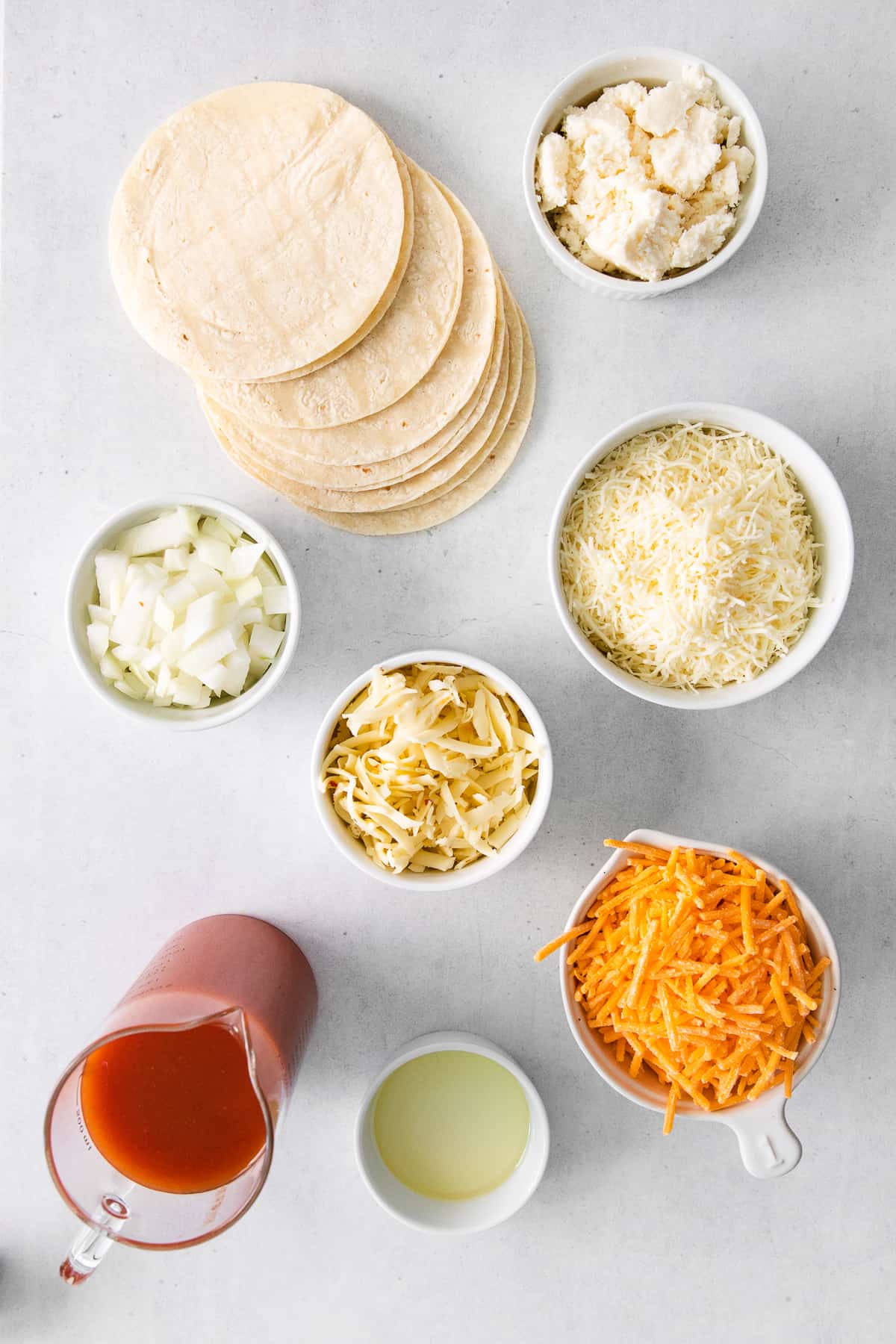 Ingredients for cheese enchiladas in bowls.