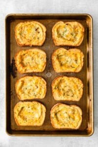 cheesy garlic bread on a baking sheet.