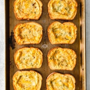 cheesy garlic bread on a baking sheet.