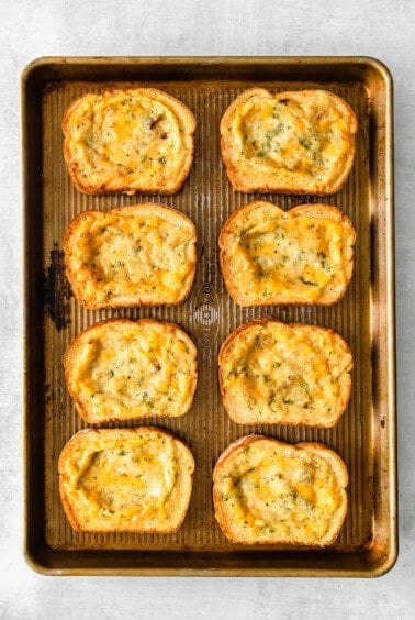 cheesy garlic bread on a baking sheet.