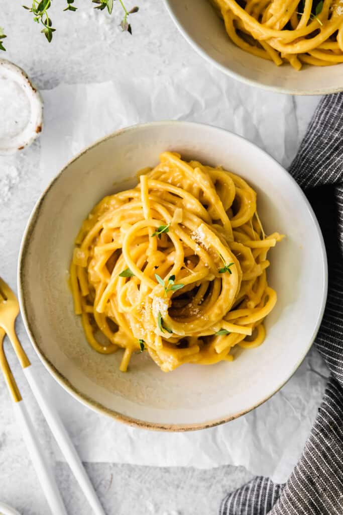 Garlic parmesan pasta topped with garnish.