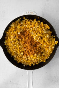 corn in a skillet on a white background.