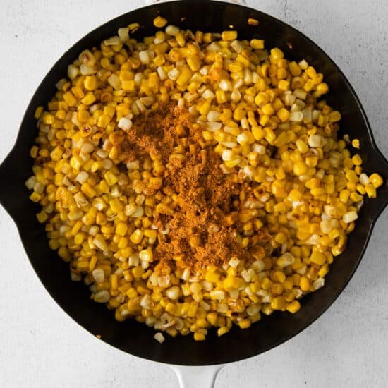corn in a skillet on a white background.