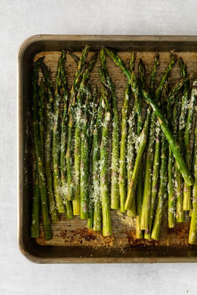 parmesan asparagus on a baking sheet