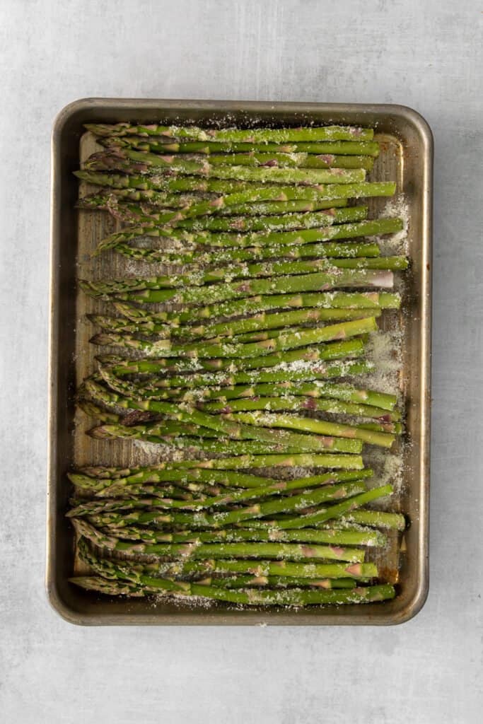 parmesan asparagus on a baking sheet