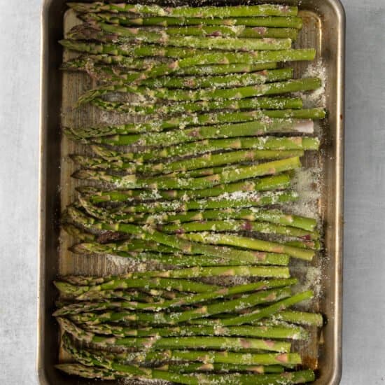 asparagus in a baking pan with parmesan.