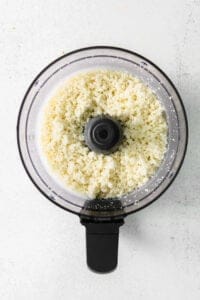a food processor filled with white rice.