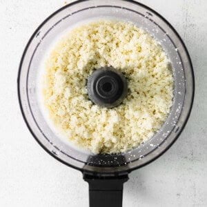 a food processor filled with white rice.