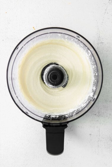whipped cream in a food processor on a white background.