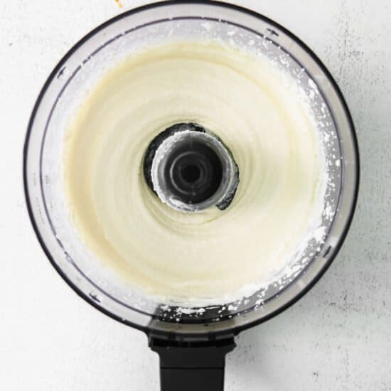 whipped cream in a food processor on a white background.