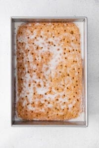 a graham cracker in a metal pan with icing.