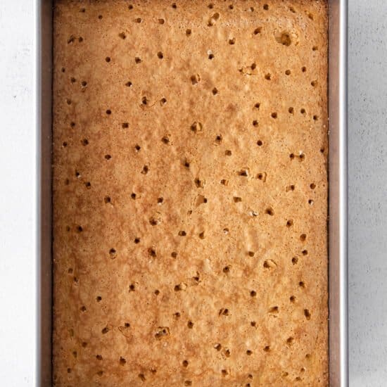 graham cracker bars in a metal pan on a white background.