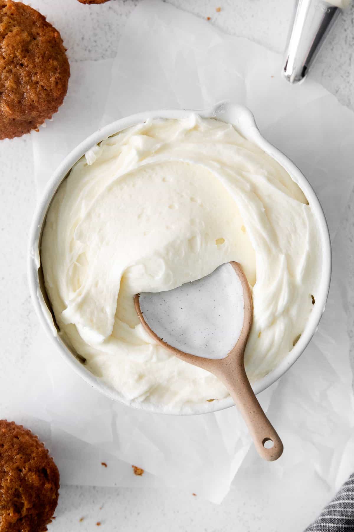 vanilla cream cheese frosting in bowl with spoon.