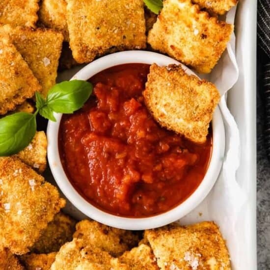 a plate of air fryer ravioli and marinara sauce