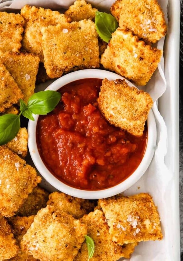a plate of air fryer ravioli and marinara sauce