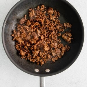 a frying pan with meat in it.