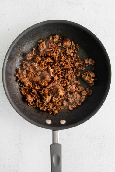 a frying pan with meat in it.