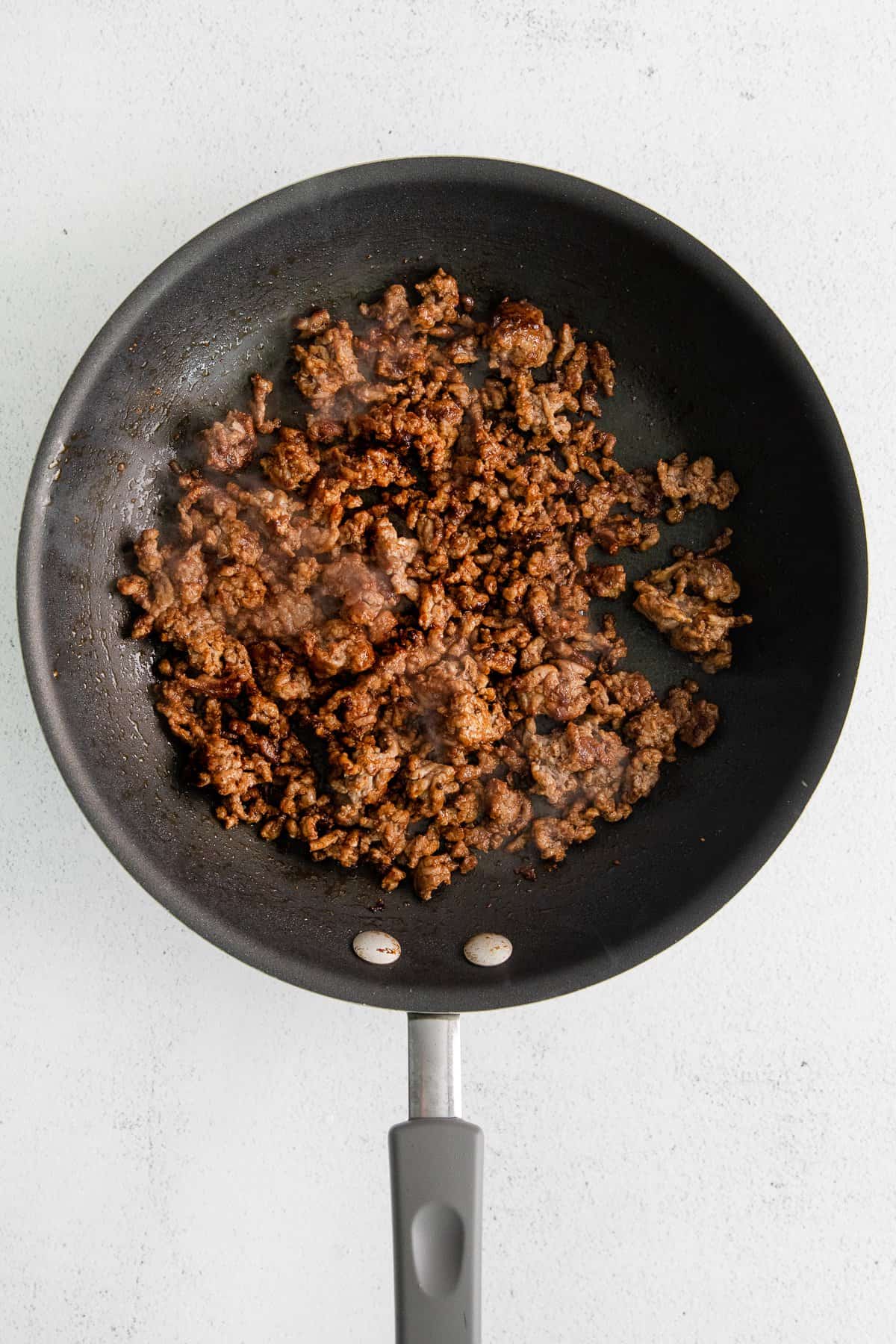 Ground beef in a skillet.