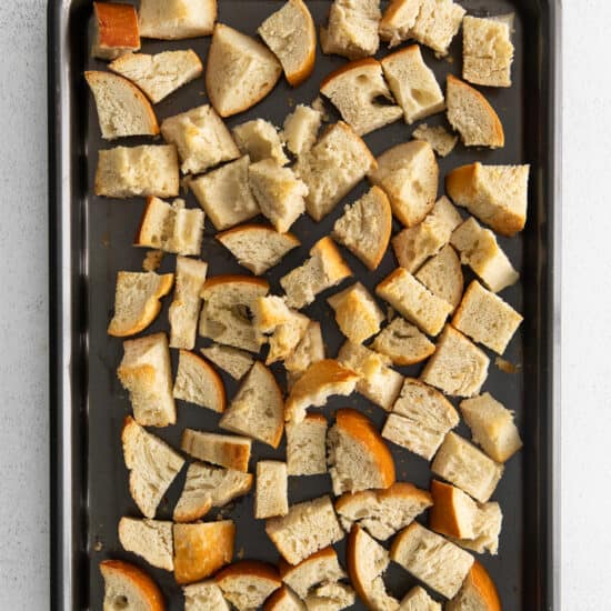 Cubes of bread on a baking sheet.