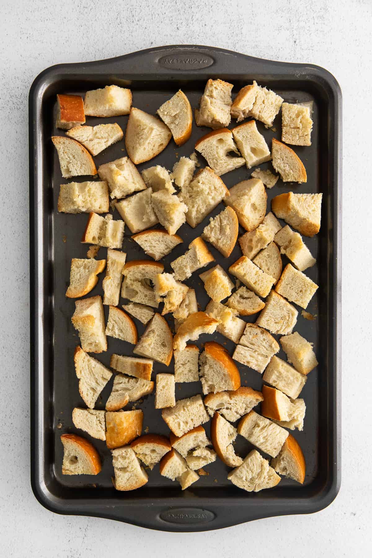 Cubes of bread on a baking sheet.