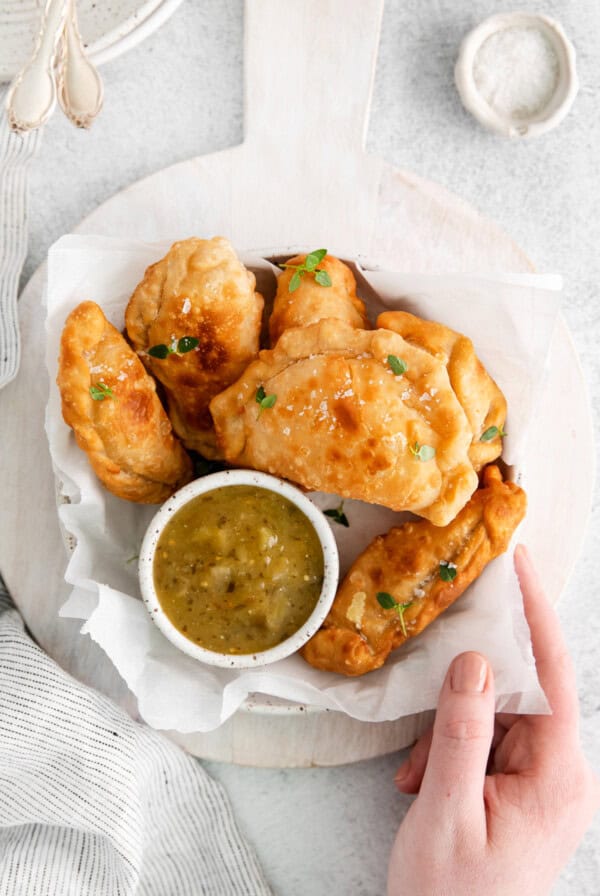 hand holding empanadas.