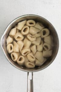 Cooked cheese tortellini in a pot.