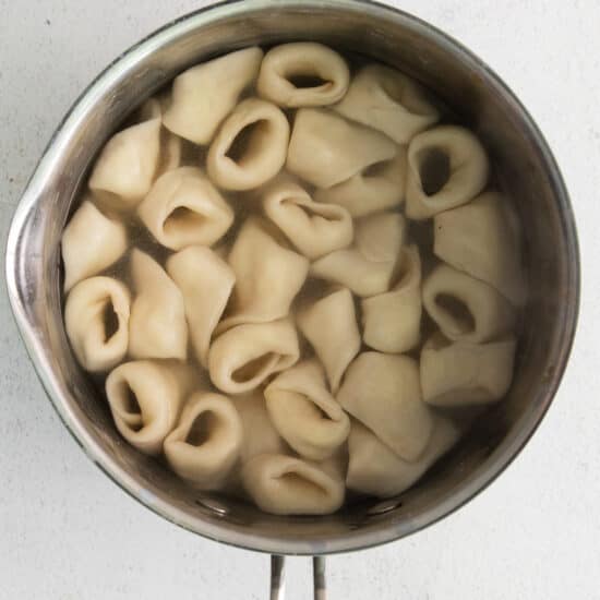 Cooked cheese tortellini in a pot.