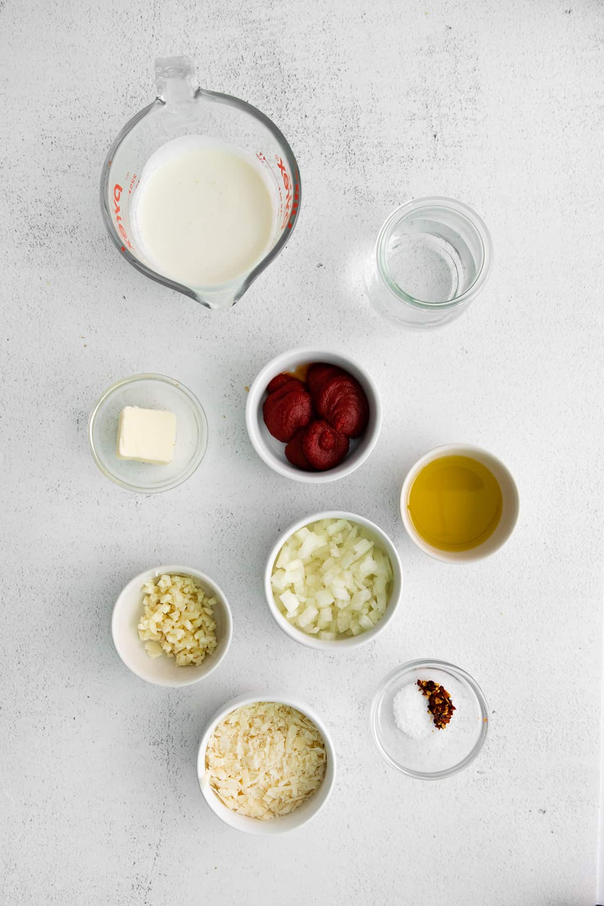 Ingredients for a vodka sauce in small bowls. 