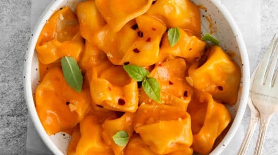 Cheese tortellini in vodka sauce in a bowl.