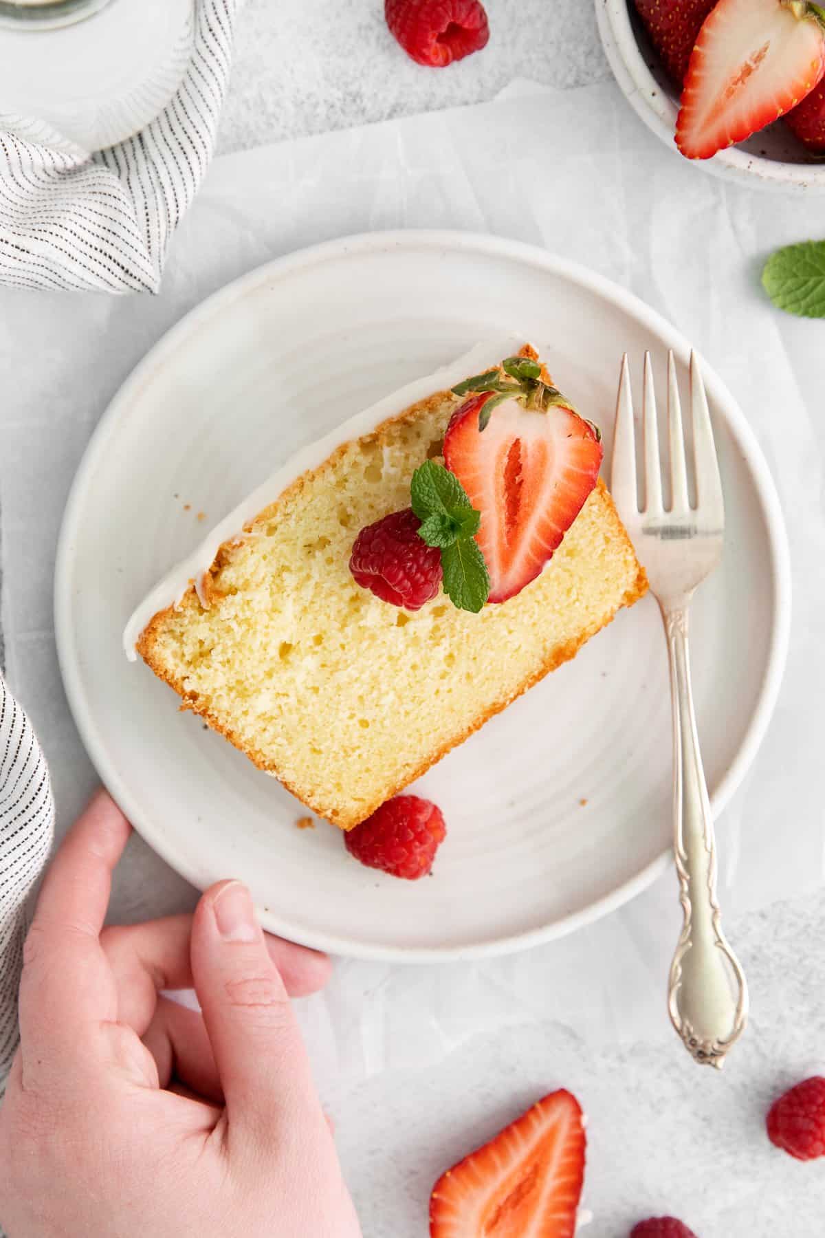 Slice of cream cheese pound cake on a plate.