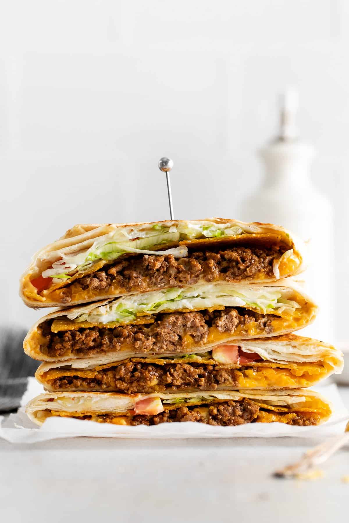 Crunchwrap supreme stacked on a plate.