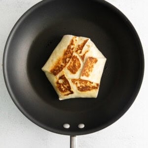 a pancake in a frying pan on a white background.