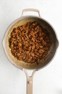 ground beef in a skillet on a white background.