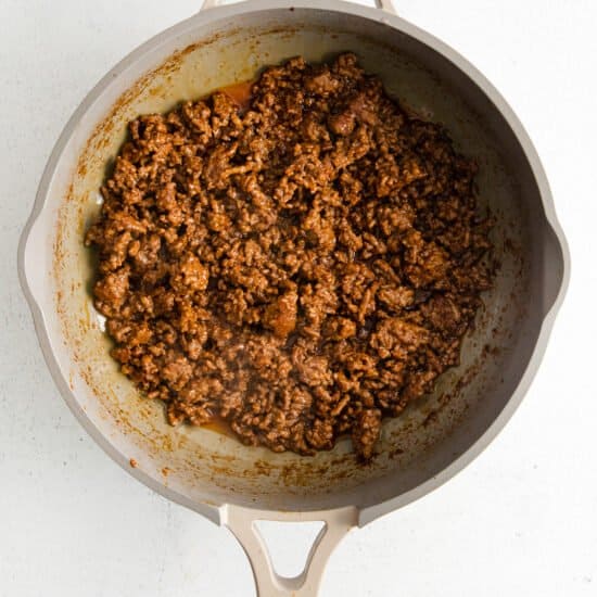 ground beef in a skillet on a white background.