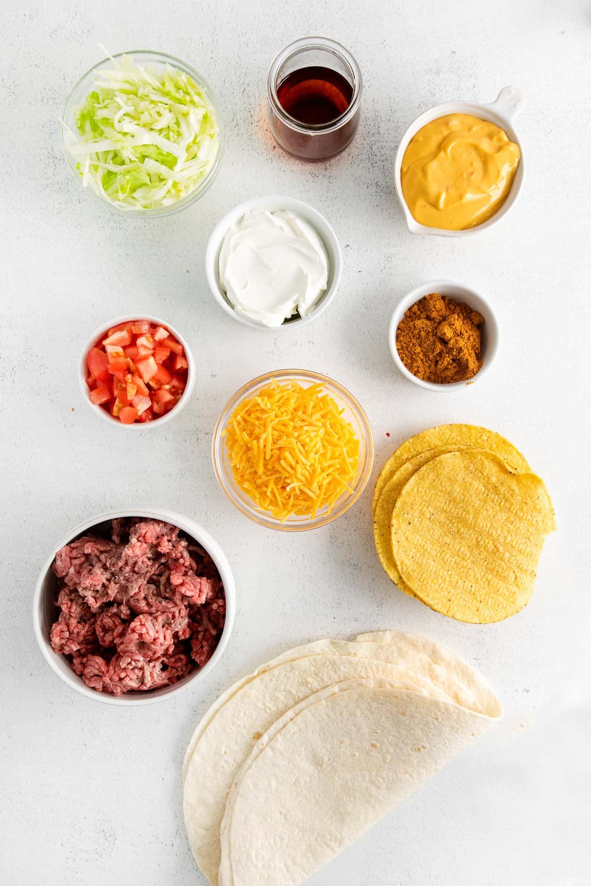 Ingredients for crunchwrap supreme in small bowls.
