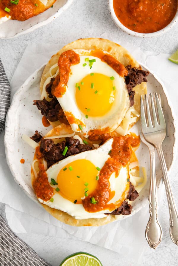 mexican breakfast tacos with eggs and salsa on a plate.