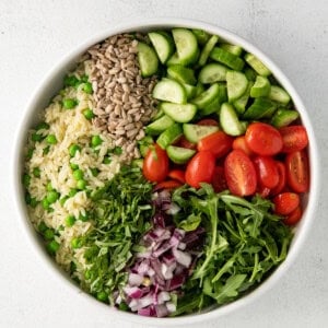 a white bowl filled with vegetables and rice.