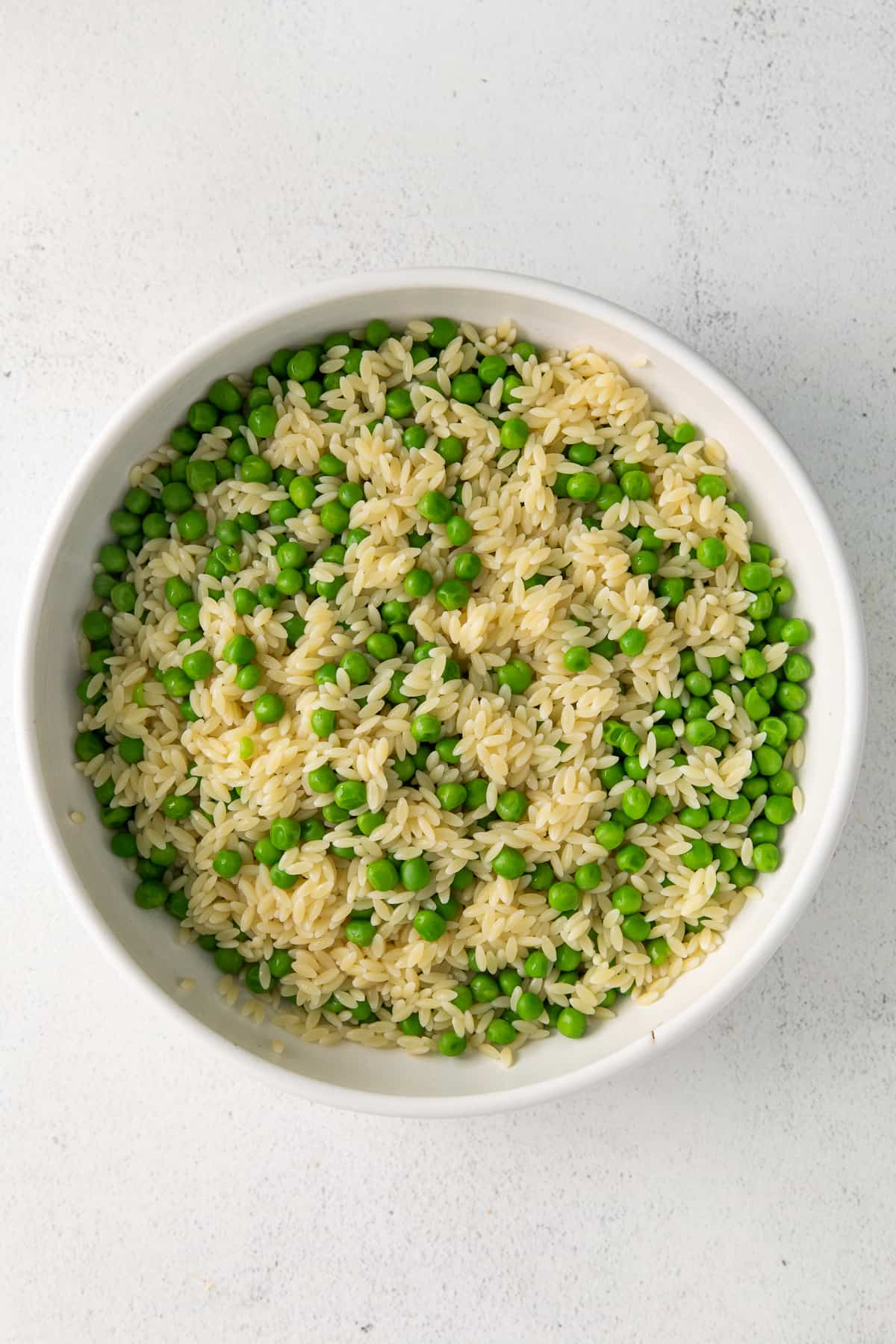 Peas and orzo in a bowl.
