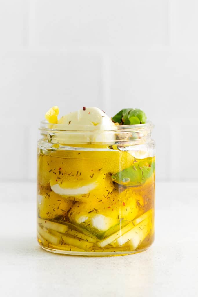 Marinated goat cheese in a jar.