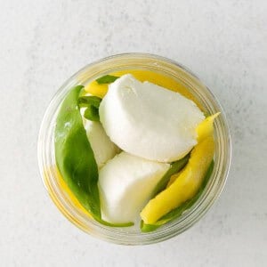 Goat cheese, lemon, and basil in a jar.