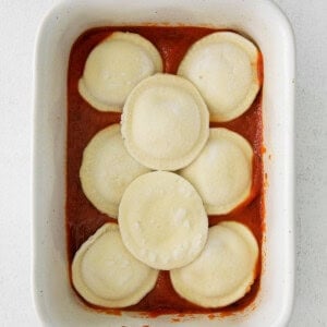 stuffed ravioli in a white baking dish.