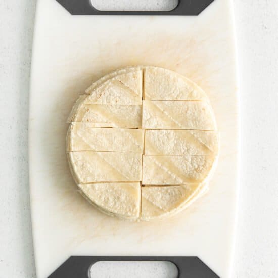 a tortilla on a cutting board on a white background.