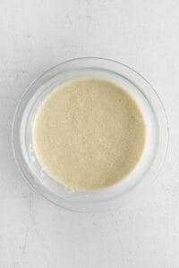 Bisquick, milk, and eggs, in a bowl.